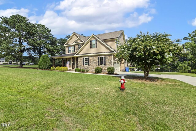 513 Goal Kick, Fuquay Varina, NC 27526 - craftsman-style house featuring stone siding, concrete driveway, a front yard, and covered porch