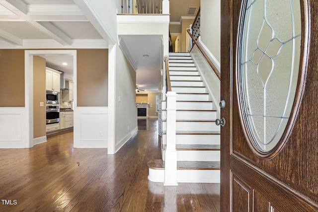 513 Goal Kick, Fuquay Varina, NC 27526 - entrance foyer featuring crown molding, stairway, dark wood-type flooring, wainscoting, and a fireplace