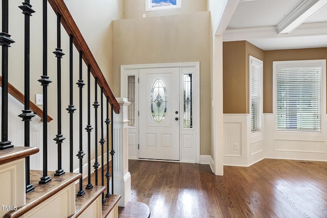 513 Goal Kick, Fuquay Varina, NC 27526 - foyer entrance featuring plenty of natural light, wood finished floors, a decorative wall, stairs, and a wainscoted wall