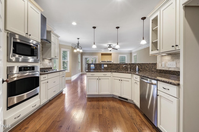 513 Goal Kick, Fuquay Varina, NC 27526 - kitchen with stainless steel appliances, ornamental molding, a peninsula, tasteful backsplash, and a ceiling fan