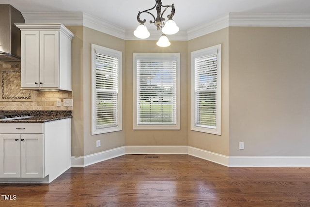 513 Goal Kick, Fuquay Varina, NC 27526 - unfurnished dining area featuring dark wood-style flooring, a chandelier, and ornamental molding