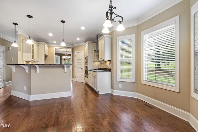513 Goal Kick, Fuquay Varina, NC 27526 - kitchen featuring a kitchen bar, a chandelier, plenty of natural light, ornamental molding, and wall chimney exhaust hood