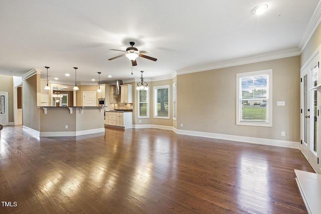 513 Goal Kick, Fuquay Varina, NC 27526 - unfurnished living room with ceiling fan, dark wood-type flooring, ornamental molding, recessed lighting, and a chandelier