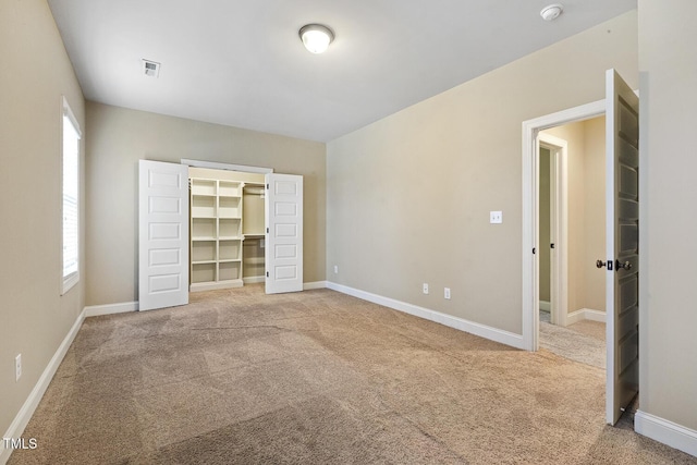 513 Goal Kick, Fuquay Varina, NC 27526 - unfurnished bedroom featuring carpet and a walk in closet