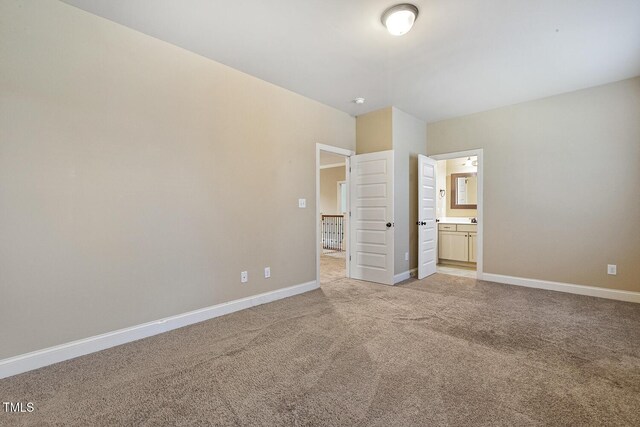 513 Goal Kick, Fuquay Varina, NC 27526 - unfurnished bedroom featuring light colored carpet and ensuite bath