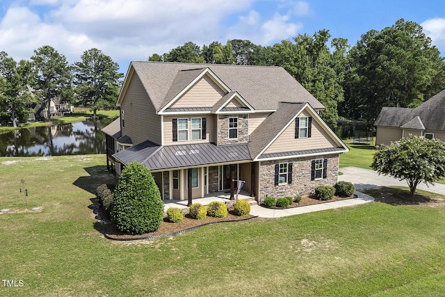 513 Goal Kick, Fuquay Varina, NC 27526 - craftsman-style house with a standing seam roof, stone siding, a porch, a water view, and a front yard