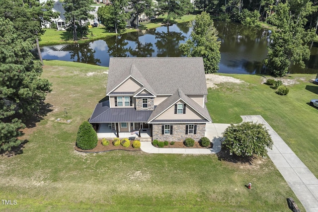 513 Goal Kick, Fuquay Varina, NC 27526 - view of front of property with a water view, stone siding, a porch, a front yard, and a metal roof