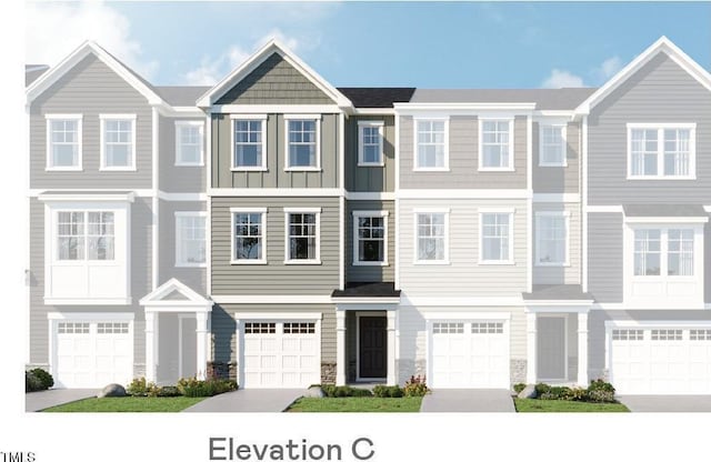 219 Carova Bnd, Apex, NC 27539 - townhome / multi-family property with an attached garage, stone siding, and driveway