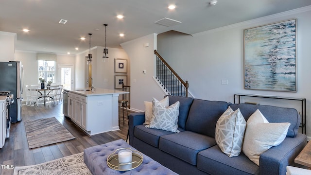 219 Carova Bnd, Apex, NC 27539 - living area featuring ornamental molding, dark wood-style floors, recessed lighting, stairs, and baseboards