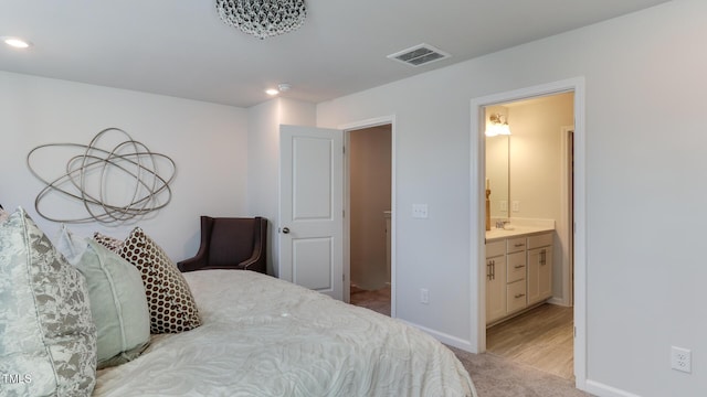 219 Carova Bnd, Apex, NC 27539 - bedroom with light colored carpet, a sink, ensuite bathroom, baseboards, and recessed lighting