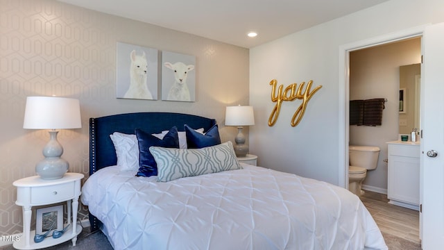 219 Carova Bnd, Apex, NC 27539 - bedroom with ensuite bathroom, baseboards, recessed lighting, and wood finished floors