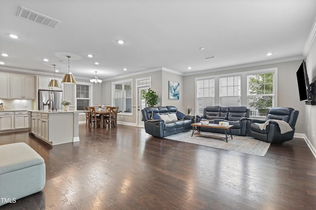 1313 Littlehills Dr, Apex, NC 27523 - living room with recessed lighting, ornamental molding, dark wood-type flooring, and a chandelier