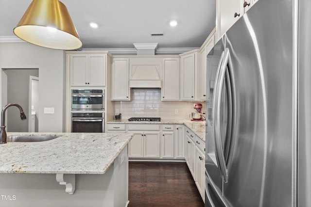 1313 Littlehills Dr, Apex, NC 27523 - kitchen featuring stainless steel fridge with ice dispenser, gas cooktop, ornamental molding, dark wood-style floors, and tasteful backsplash