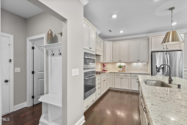 1313 Littlehills Dr, Apex, NC 27523 - kitchen with appliances with stainless steel finishes, dark wood-style floors, light stone counters, decorative backsplash, and decorative light fixtures