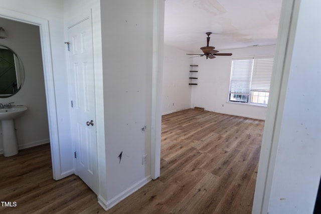 328 Mccarthy Dr, Clayton, NC 27527 - hallway featuring wood finished floors, baseboards, a sink, and cooling unit