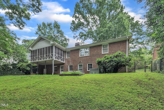 3304 Redbud Ln, Raleigh, NC 27607 - back of house featuring a sunroom, brick siding, and a gate
