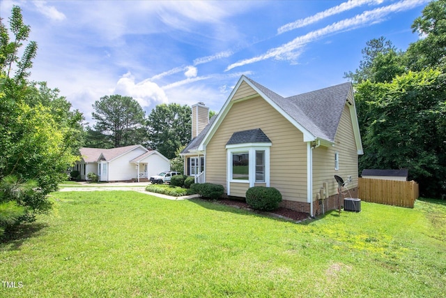1309 Sweet Charm Ln, Knightdale, NC 27545 - view of front facade featuring a chimney, a front yard, and roof with shingles