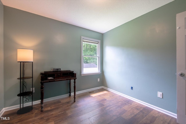 1309 Sweet Charm Ln, Knightdale, NC 27545 - office with wood finished floors, vaulted ceiling, and a textured ceiling
