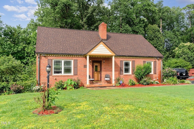 132 Lord Ashley Rd, Raleigh, NC 27610 - view of front of house featuring brick siding, a chimney, and a front lawn