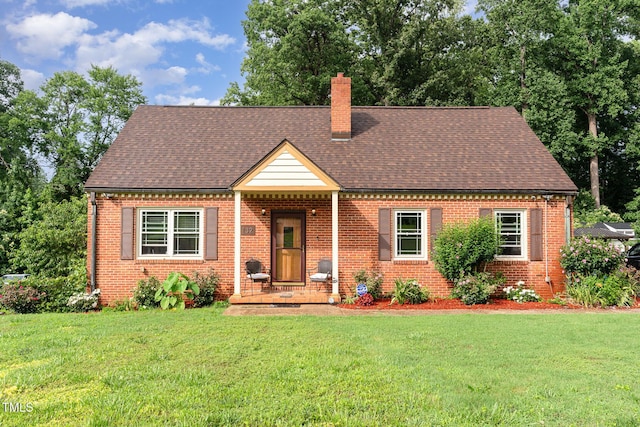 132 Lord Ashley Rd, Raleigh, NC 27610 - view of front of home with a chimney, brick siding, and a front lawn
