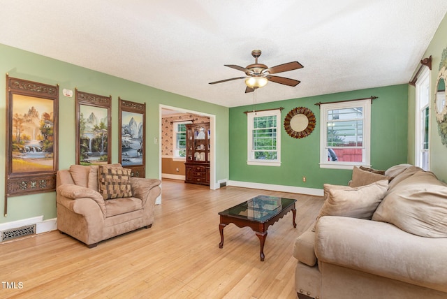 132 Lord Ashley Rd, Raleigh, NC 27610 - living room with a ceiling fan, wood finished floors, and a textured ceiling