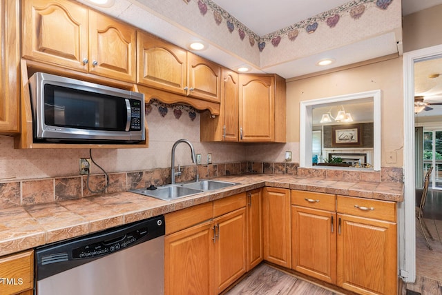 132 Lord Ashley Rd, Raleigh, NC 27610 - kitchen featuring appliances with stainless steel finishes, tasteful backsplash, light wood-style floors, light countertops, and ceiling fan