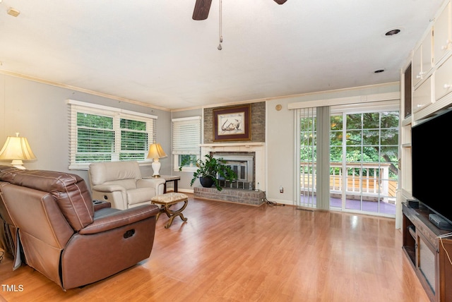 132 Lord Ashley Rd, Raleigh, NC 27610 - living room with ceiling fan, light wood-style floors, ornamental molding, and a fireplace