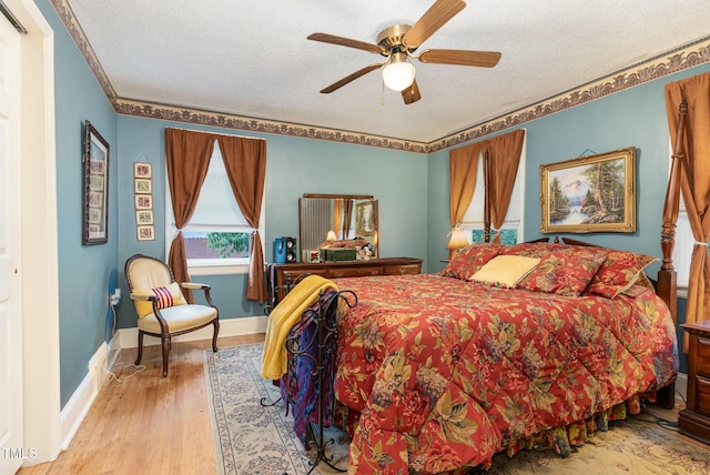 132 Lord Ashley Rd, Raleigh, NC 27610 - bedroom with wood finished floors, a textured ceiling, and ceiling fan