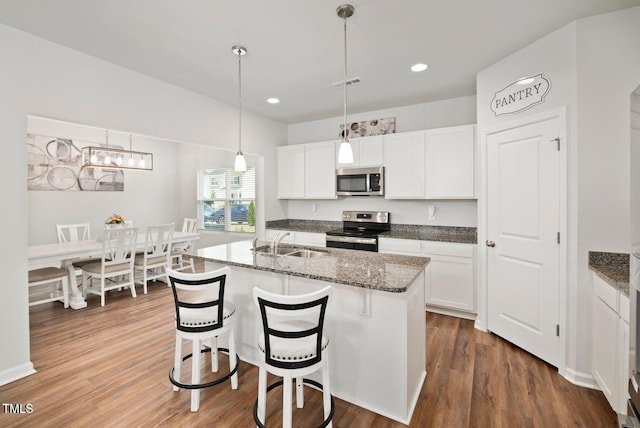 10 Forest Brook Way, Clayton, NC 27520 - kitchen with appliances with stainless steel finishes, a sink, white cabinets, dark wood-style floors, and recessed lighting