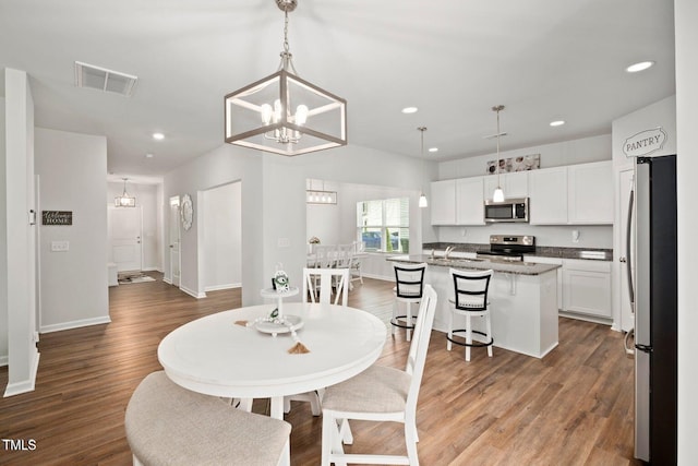 10 Forest Brook Way, Clayton, NC 27520 - dining room with recessed lighting, a chandelier, wood finished floors, and baseboards