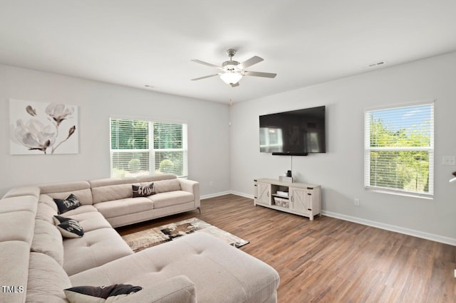 10 Forest Brook Way, Clayton, NC 27520 - living area featuring plenty of natural light, ceiling fan, wood finished floors, and baseboards