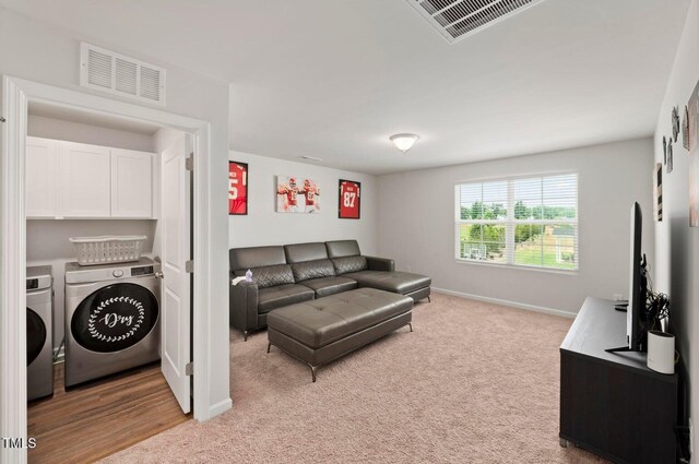 10 Forest Brook Way, Clayton, NC 27520 - living room featuring washer and clothes dryer, baseboards, and light carpet