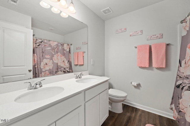 10 Forest Brook Way, Clayton, NC 27520 - bathroom featuring double vanity, toilet, wood finished floors, baseboards, and a shower with curtain
