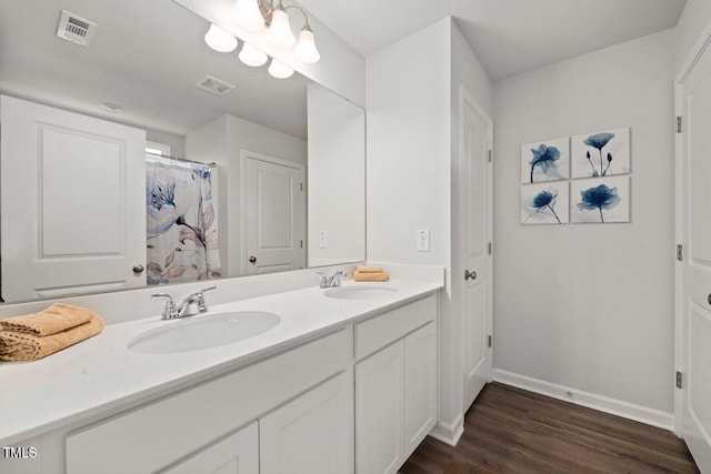 10 Forest Brook Way, Clayton, NC 27520 - full bath with double vanity, wood finished floors, baseboards, and a shower with curtain