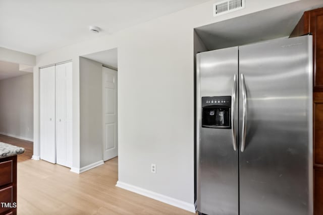 104 Benedict Ln, Raleigh, NC 27614 - kitchen featuring stainless steel fridge, light wood-style flooring, baseboards, and light stone counters