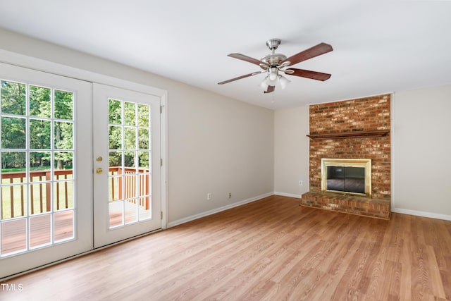 104 Benedict Ln, Raleigh, NC 27614 - unfurnished living room featuring wood finished floors, ceiling fan, baseboards, and a brick fireplace