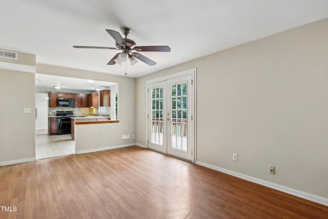 104 Benedict Ln, Raleigh, NC 27614 - unfurnished living room featuring french doors, light wood finished floors, a ceiling fan, and baseboards