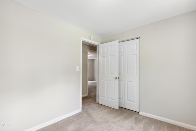 104 Benedict Ln, Raleigh, NC 27614 - unfurnished bedroom with light carpet, baseboards, and a closet