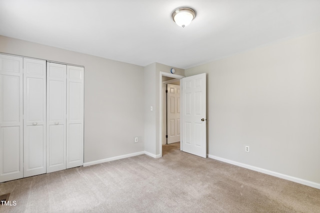 104 Benedict Ln, Raleigh, NC 27614 - unfurnished bedroom featuring light colored carpet, baseboards, and a closet