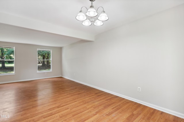 104 Benedict Ln, Raleigh, NC 27614 - spare room featuring light wood finished floors, baseboards, and a chandelier