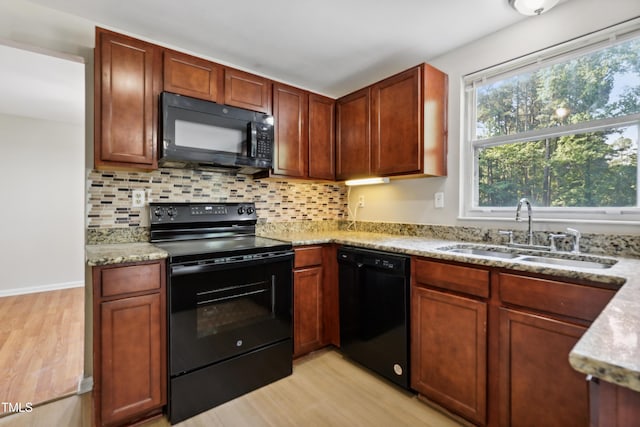 104 Benedict Ln, Raleigh, NC 27614 - kitchen with black appliances, a sink, light wood-type flooring, and plenty of natural light