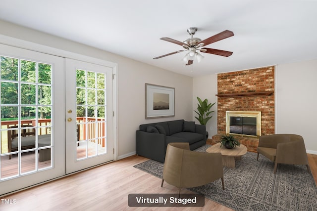 104 Benedict Ln, Raleigh, NC 27614 - living area featuring wood finished floors, ceiling fan, baseboards, and a brick fireplace