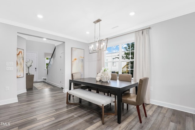 321 Calvander Ln, Apex, NC 27539 - dining area featuring wood finished floors, a chandelier, baseboards, crown molding, and recessed lighting
