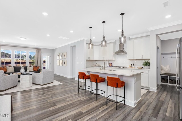 321 Calvander Ln, Apex, NC 27539 - kitchen featuring a sink, light countertops, a breakfast bar, dark wood-style floors, and recessed lighting