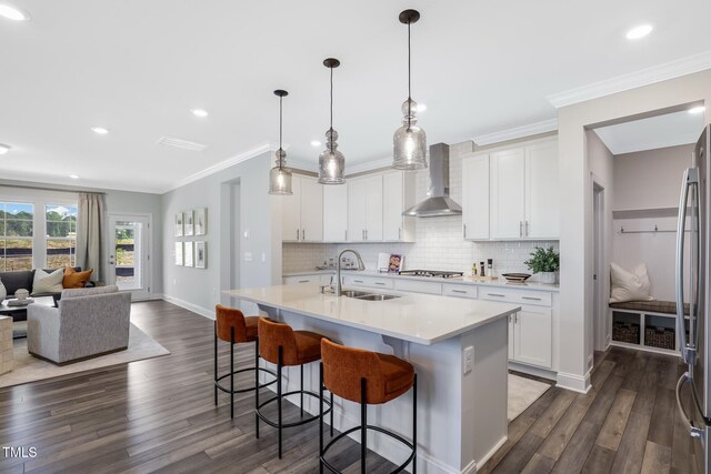 321 Calvander Ln, Apex, NC 27539 - kitchen with wall chimney range hood, a sink, dark wood-style flooring, light countertops, and recessed lighting