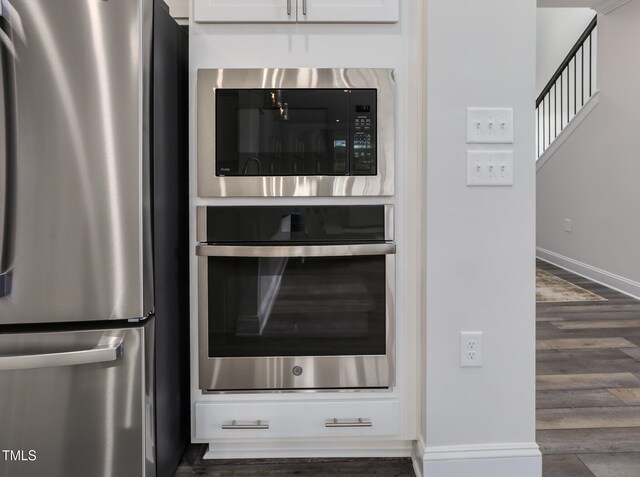 321 Calvander Ln, Apex, NC 27539 - kitchen with appliances with stainless steel finishes, wood finished floors, baseboards, and white cabinetry