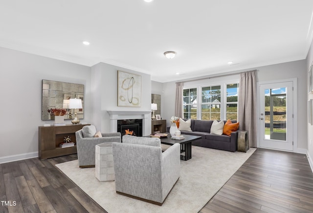 321 Calvander Ln, Apex, NC 27539 - living area with a lit fireplace, wood finished floors, recessed lighting, crown molding, and baseboards