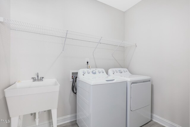 321 Calvander Ln, Apex, NC 27539 - laundry room with washer and clothes dryer, baseboards, and light wood-style flooring