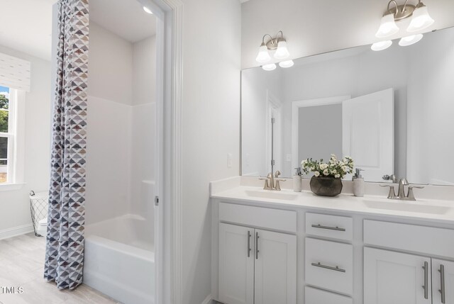 321 Calvander Ln, Apex, NC 27539 - bathroom with double vanity, shower / bath combination with curtain, and baseboards