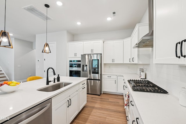 772 Mirkwood Ave, Apex, NC 27523 - kitchen featuring stainless steel appliances, wall chimney range hood, light countertops, white cabinetry, and recessed lighting